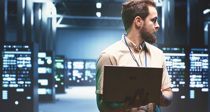 DevOps inženjer sa laptopom u data centru
